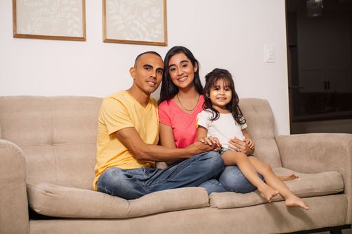 A latin american family together in a sofa at home.