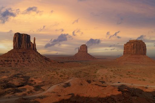 A tranquil scene of Monument Valley in Utah, USA, featuring a vast desert landscape with unique rock formations