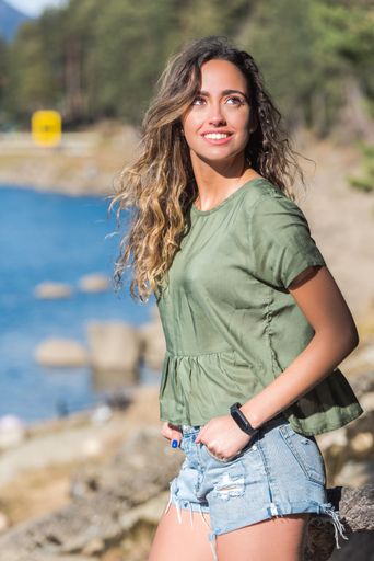 A vertical shot of a beautiful attractive woman posing and smiling