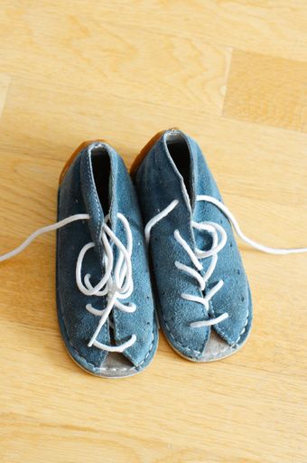 Pair of blie baby sandals on wooden floor