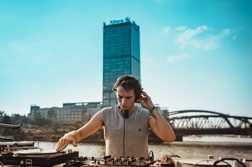 DJ Alle Farben playing an exhilarating set at Lollapalooza Berlin on a boat in front of a captivated audience