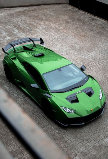 A vertical shot of a beautiful sleek luxurious Lamborghini Huracan Sto parked outdoors