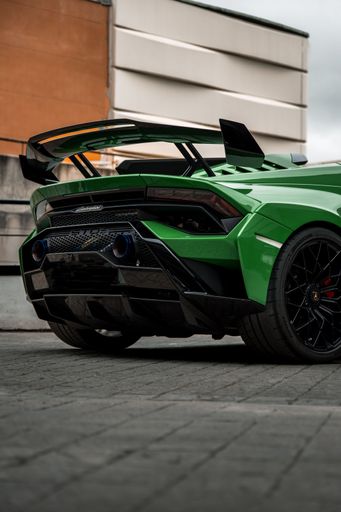 A vertical shot of a beautiful sleek luxurious Lamborghini Huracan Sto parked outdoors