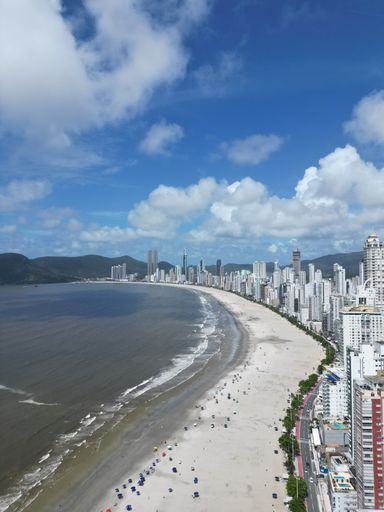 An aerial view of buildings near an ocean in Balneario Camboriu
