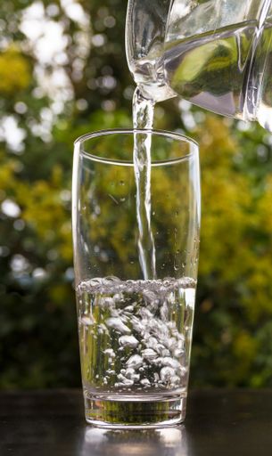 A closeup shot of water pouring into a glass