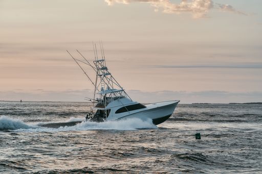 A large fishing vessel is seen navigating through the choppy waters of the open ocean