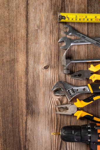 A vertical shot of repair tools on a wooden table- concept for labor day