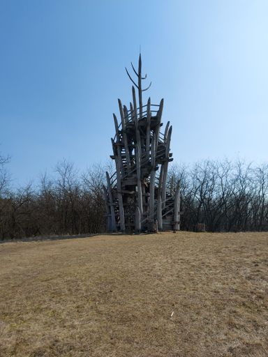 A vertical shot of a wooden watchtower with a spiral staircase at Harangod in Nagykallo, Hungary