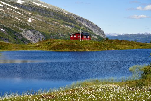 Off-grid, red, wooden cabin in Norway, powered by solar energy