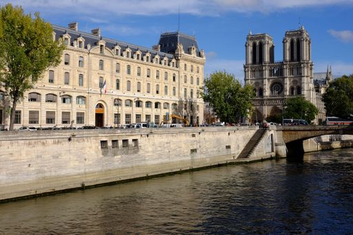 A scenic view of River Seine in Paris with the iconic Notre-Dame de Paris cathedral in the backdrop