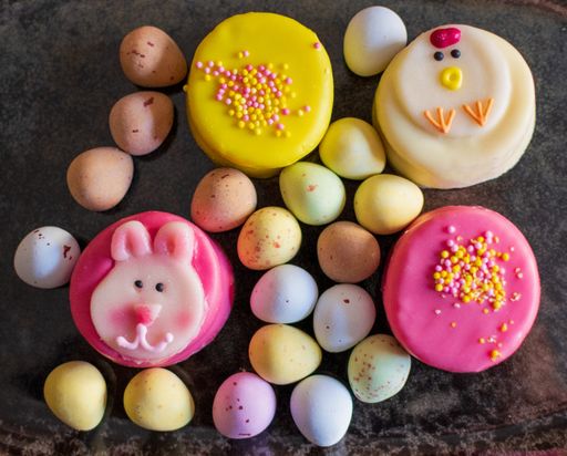 A top view shot of Easter decoration with eggs and colorful sweets on the table background