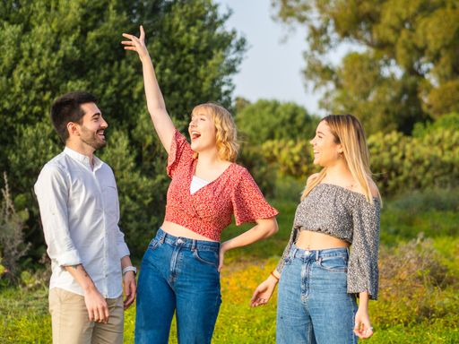A group of happy young people hanging out together in the park
