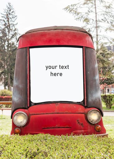 A blank billboard in the shape of an old red car in a park