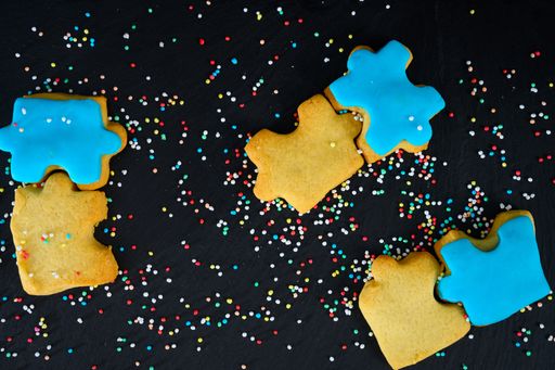 A top view of delicious cookies with sprinkles and icing