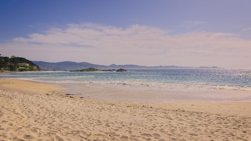 The blue sea and sandy shore on a sunny day