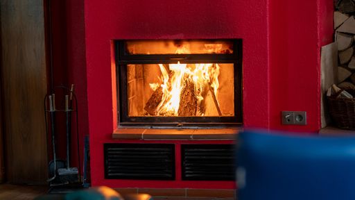 A selective focus shot of burning firewood in the fireplace