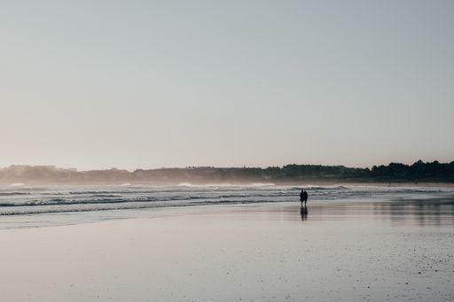 A beautiful shot of people walking on a beach on a sunny summer day in Galicia, Spain