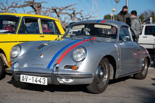 Detail of a beautiful classic silver Porsche 356 with blue and red lines