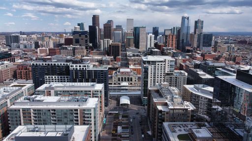 An aerial view of skyscrapers of Denver, Colorado under a cloudy sky