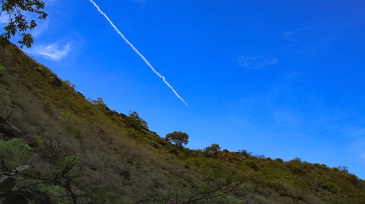 A low angle shot of a hill under blue sky