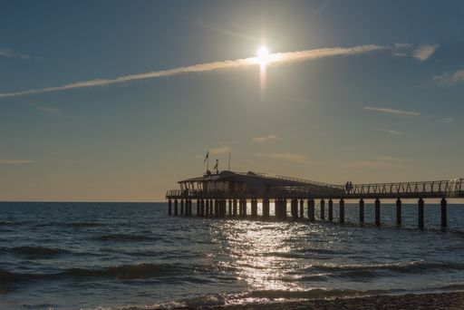 A wide angle shot of the sun shining over the beach during daytime