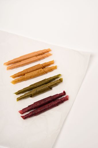 Pattern pastila fruit leather rolls up with fruits on white background. Vertically.