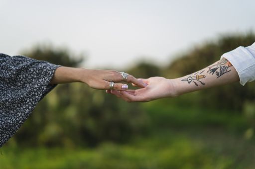 A shallow focus shot of two hands touching each other gently