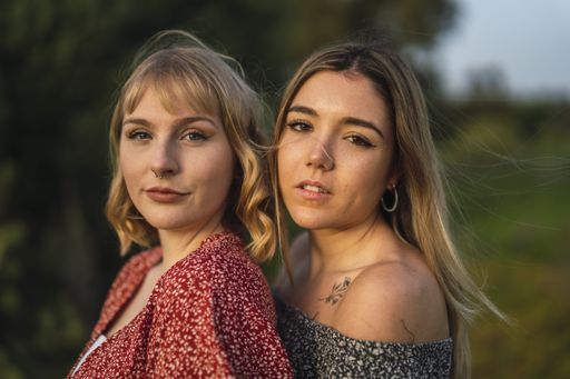A young lesbian couple cuddling each other in nature