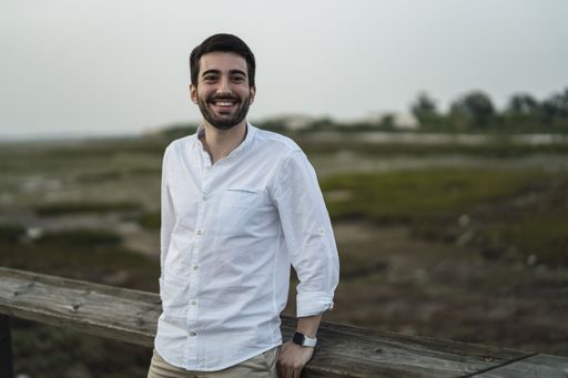 A shallow focus shot of a happy Spanish Caucasian young man in the park
