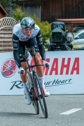 A man riding a bicycle down a lane during a competition