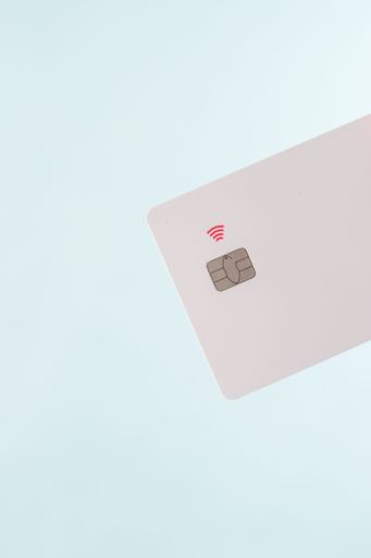 A closeup shot of a white, blank credit card with a Near Field Communication (NFC) chip