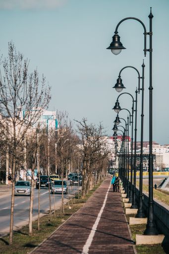 Iasi - Romania - 13th March 2021: Children walking on the sidewalk and cars on the road