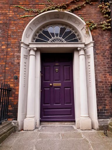 Decorative purple front door of Georgian townhouse in Dublin, Ireland.