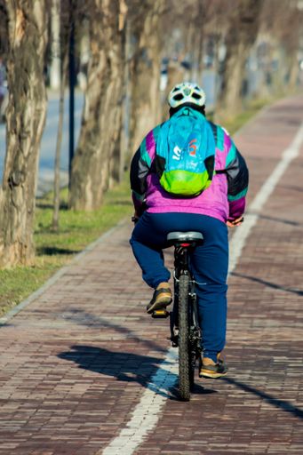 Iasi - Romania - 13th March 2021: Person riding a bike on the sidewalk during a sunny day