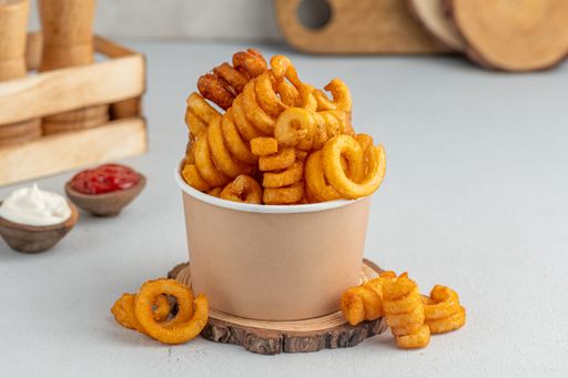 A closeup of a white cup with Curly Fries with sauces