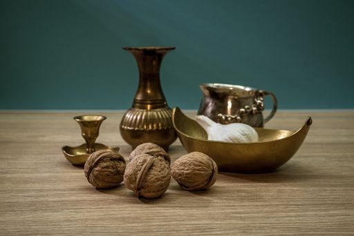 A closeup shot of still-life with coffee drip set and nuts on the wooden surface