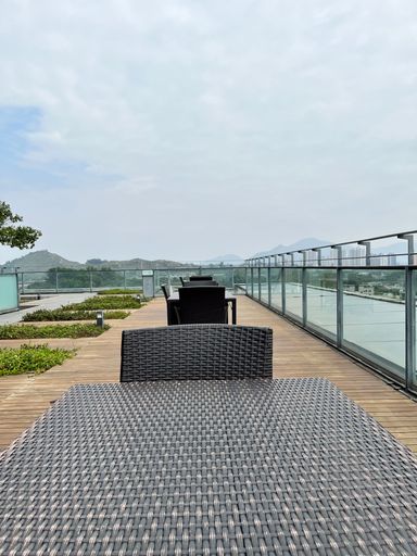 A vertical of an outdoor dining area with patio furniture on a cloudy day