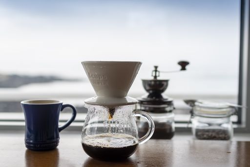 A closeup shot of coffee filtering into a glass pot