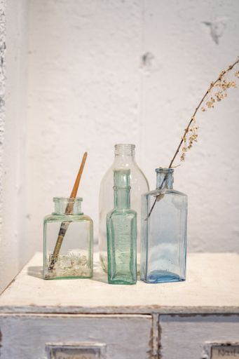 A vertical shot of antique glass bottles as decorations