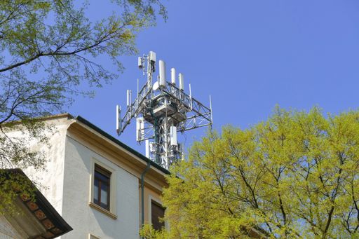 A new 5G communication tower on residential building in urban scenery