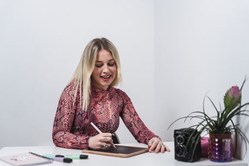 A young Caucasian female from Spain working and taking notes on a tablet with a smartpen