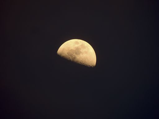 A breathtaking shot of the half-moon in the dark sky at night