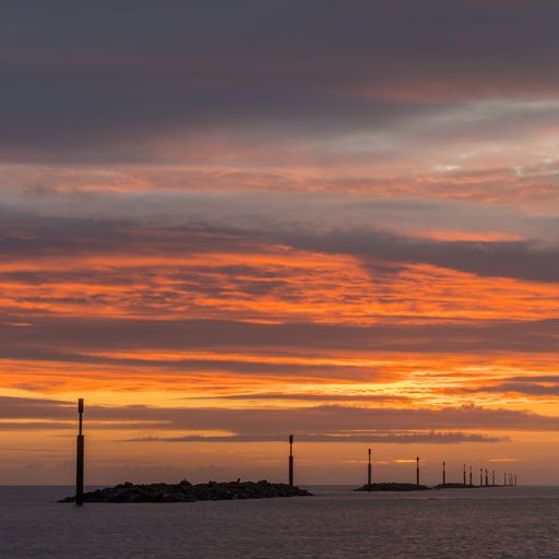 A picturesque view of a stunning tranquil sunrise sky over the Sea Palling