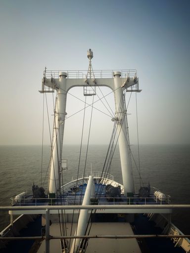 A vertical shot of a floating crane