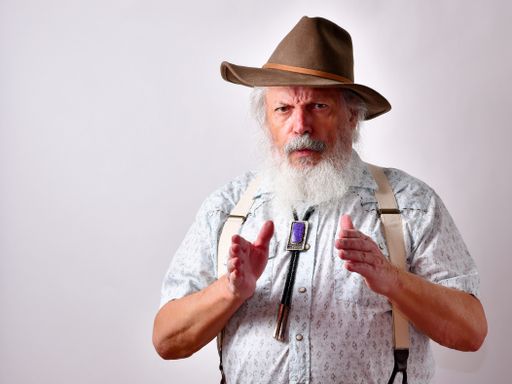 A senior Caucasian bearded male describing the size of an object on white background