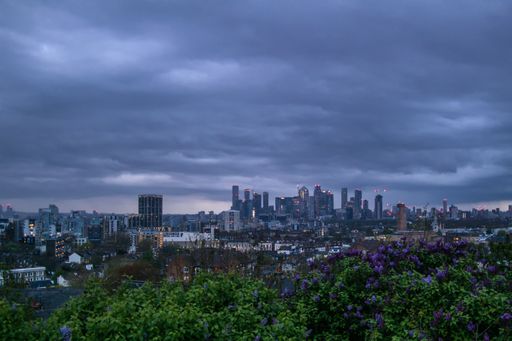 Dense clouds hanging over Central London in the evening in April as seen from a hill in the Greenwich area