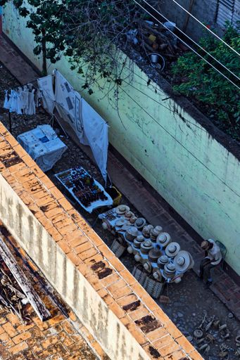 A vertical high angle shot of an old neighborhood with a laundry cable