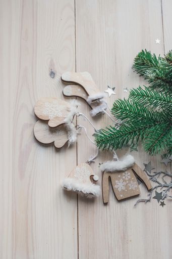 A high angle vertical of wooden ornaments and Christmas decorations on the table