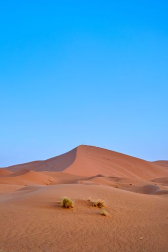 A beautiful view of the desert landscape with sand dunes in the foreground Sahara Desert, Morocco