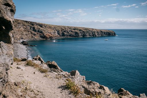 The rocky cliffs overlook over a secluded beach and ocean area, La Gomera, Canary Islands, Spain